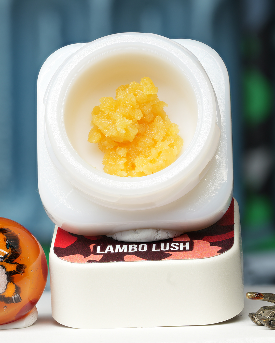 Lambo Lush BHO caviar jar with bright golden concentrate in Dank Tank studio photography
