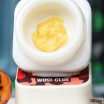 Wosi Glue BHO caviar jar with pale golden creamy concentrate in Dank Tank studio photography