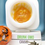Drunk GMO BHO caviar jar with glossy golden concentrate in Dank Tank studio photography