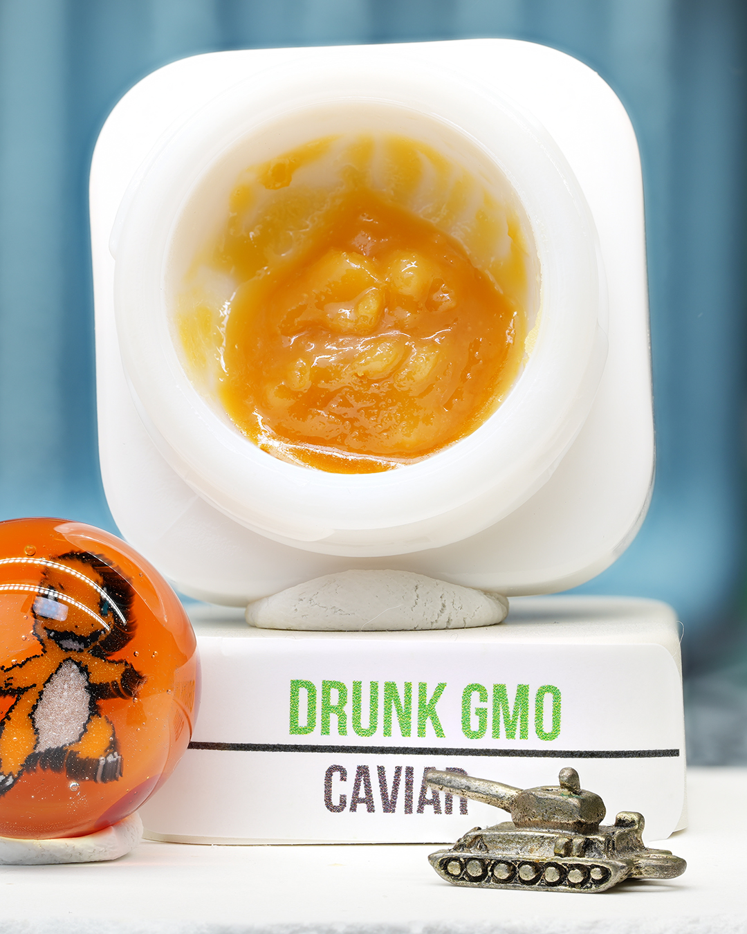 Drunk GMO BHO caviar jar with glossy golden concentrate in Dank Tank studio photography