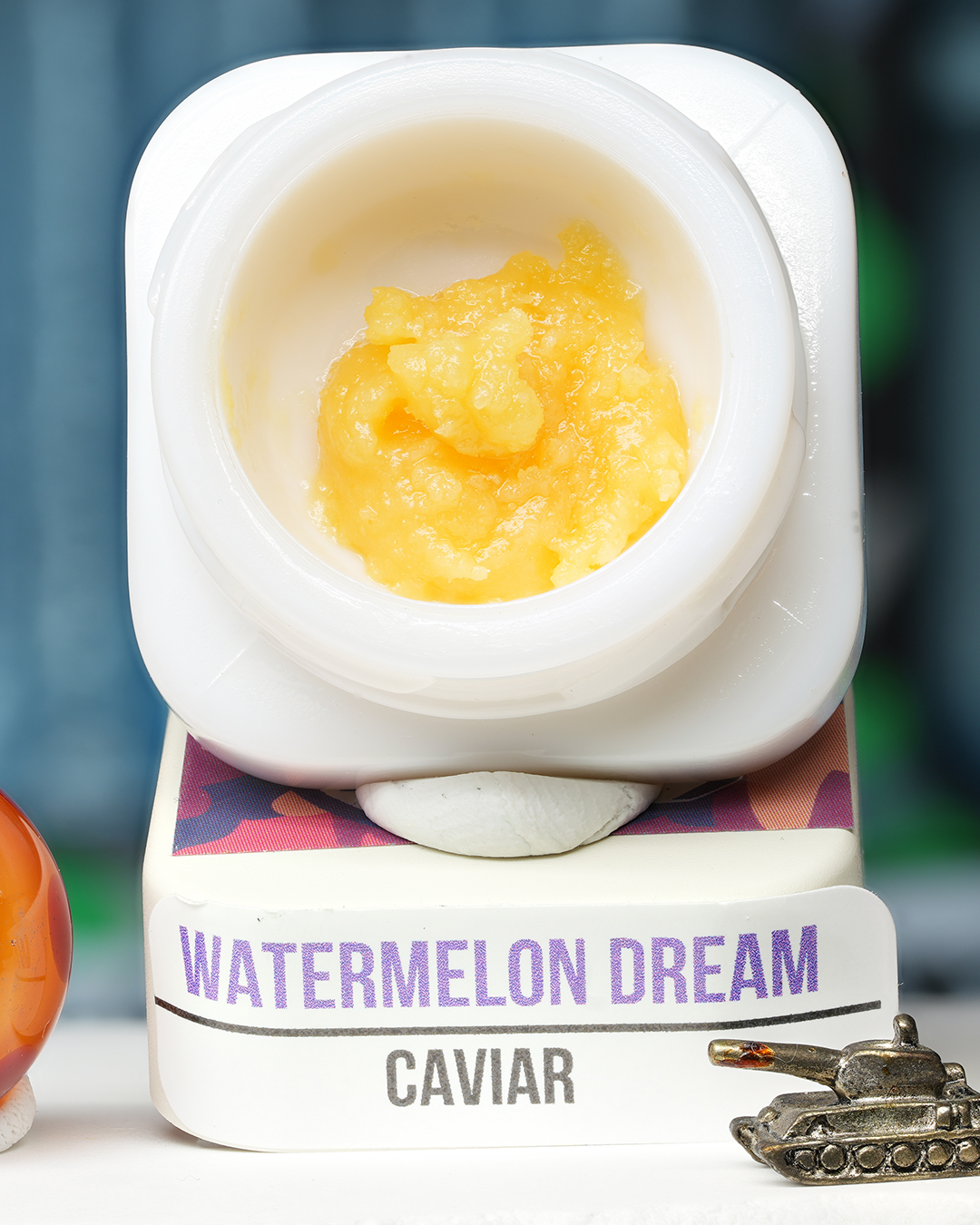 Watermelon Dream BHO caviar jar with glossy golden concentrate in Dank Tank studio photography