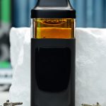 2000mg LA Confidential Nuke All-in-One vape with Afghani and California Indica lineage, earthy pine, kush gas, and sedating effects