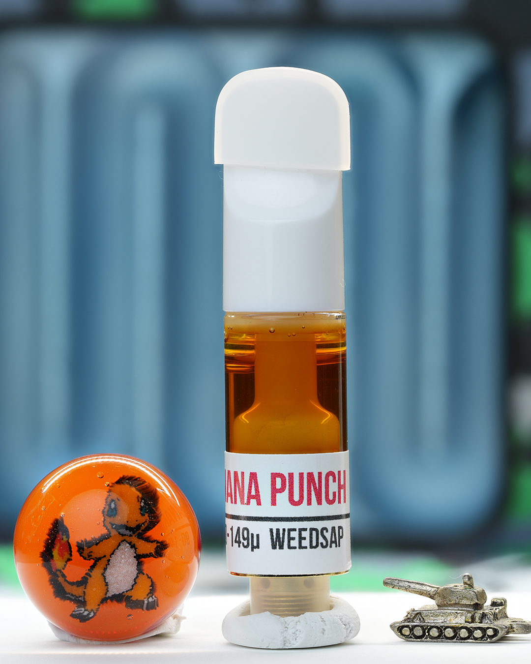 Banana Punch 1g rosin cartridge photographed with Dank Tank studio props and amber rosin oil